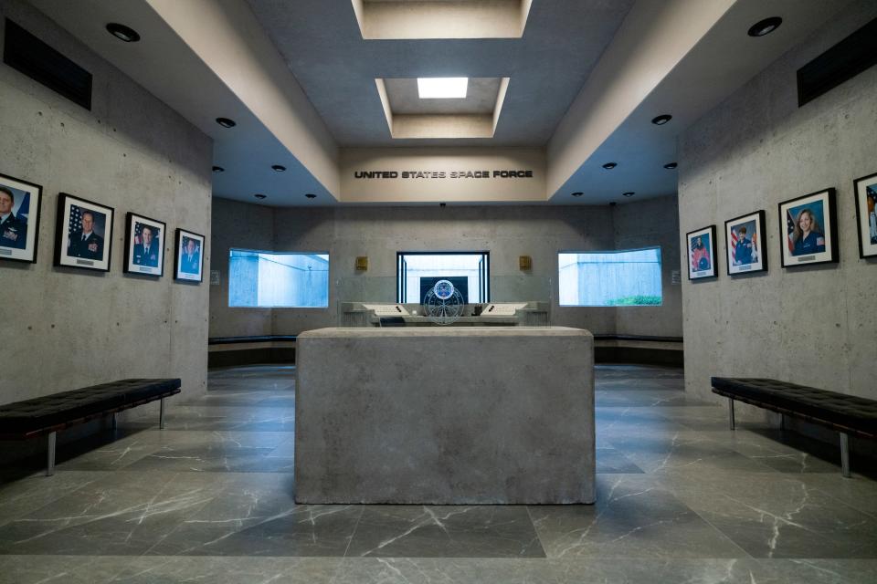 Gray concrete walls and marble floors were used as a contrasting backdrop for the blue and gray military uniforms.