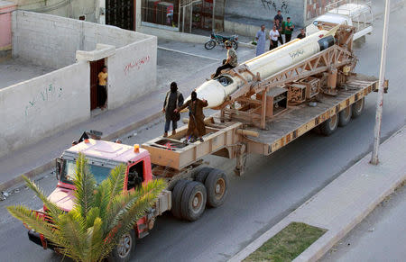 FILE PHOTO - Militant Islamist fighters take part in a military parade along the streets of Syria's northern Raqqa province June 30, 2014. REUTERS/Stringer/File Photo