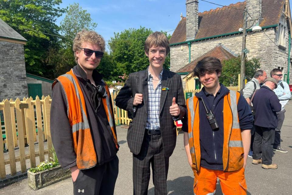 Trainspotter Francis Bourgeois (middle) was at Corfe Castle station on Sunday where he posed for pictures with fellow railway enthusiasts. Also pictured: Swanage Railway volunteers George Miller (left) and Sam Smith (right). <i>(Image: Swanage Railway)</i>