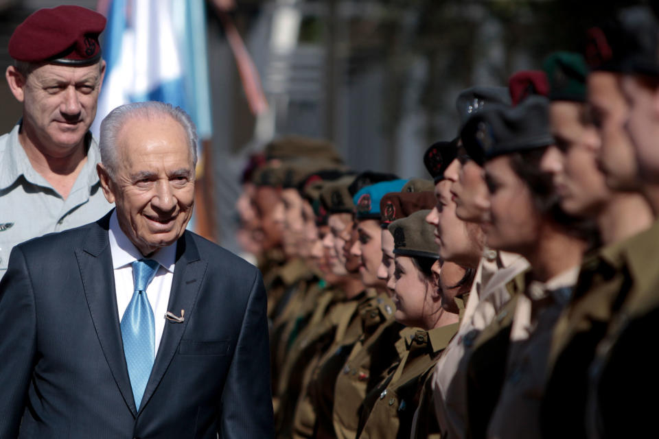 <p>Israeli President Shimon Peres, second left, surveys the honor guard with Israeli Defense Forces Chief of Staff Benny Ganz, left, during Israel’s 63rd Independence Day event at his residence, in Jerusalem, Tuesday, May 10, 2011. (AP Photo/Tara Todras-Whitehill) </p>