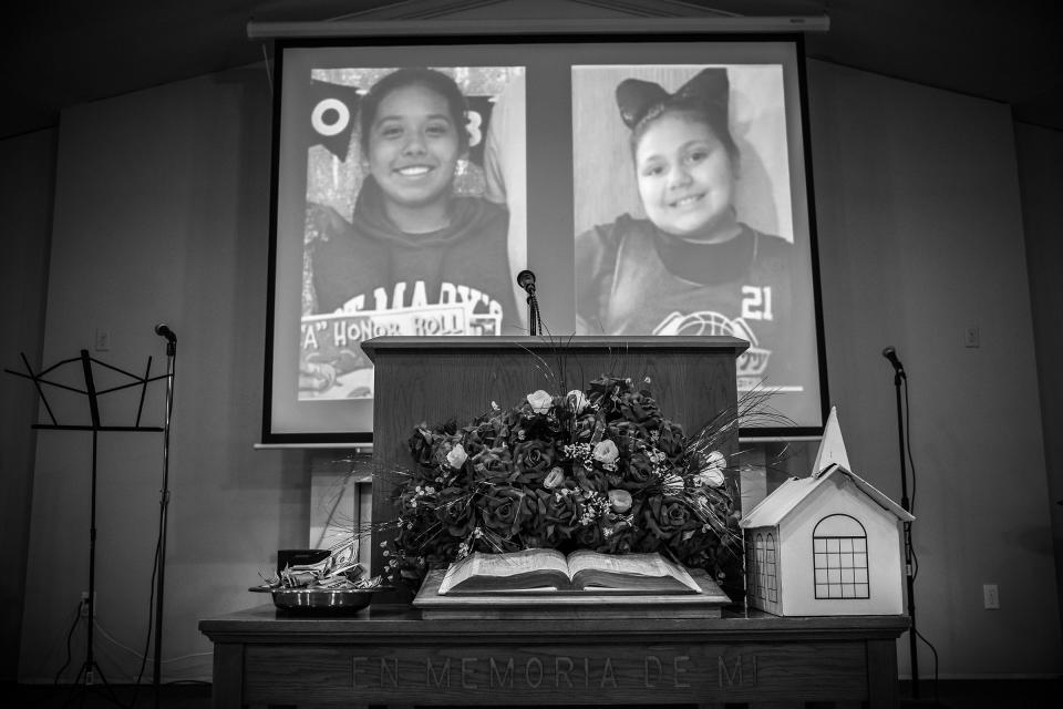 The photographs of Lexi Rubio, left, and Eliahna Garcia, students at Robb Elementary school who were killed in the recent mass shooting are projected during a service at Iglecia Bautista church on May 29, 2022.<span class="copyright">David Butow—Redux</span>