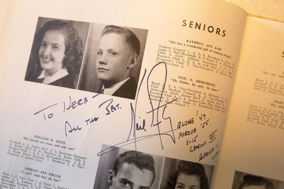 A high school yearbook owned by Herb Lunz is signed by Neil Armstong near Armstrong's photo, his quote reads, "Neil A. Armstrong, He thinks, he acts, 'tis done."