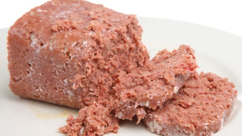 Sliced canned corned beef on white plate