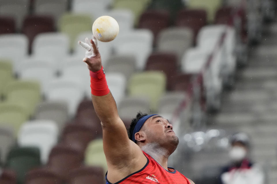 FILE - In this Tuesday, Aug. 31, 2021, file photo, Muhammad Ziyad Zolkefli of Malaysia competes in the men's shot put F20 final during the Tokyo 2020 Paralympics Games at the National Stadium in Tokyo, Japan. Zolkefli appeared to have won gold in the shot put in the F20 class. But after the victory on Tuesday, he was disqualified because he had shown up late for the competition. (AP Photo/Eugene Hoshiko, File)