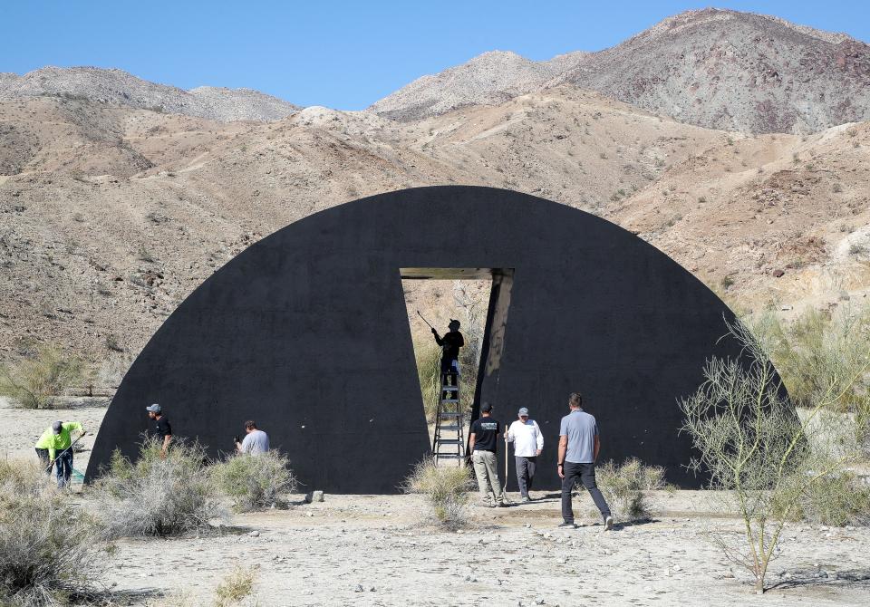 A construction crew puts the final touches on "Liquid A Place" during the Desert X exhibition in Palm Desert, Calif., March 3, 2023.