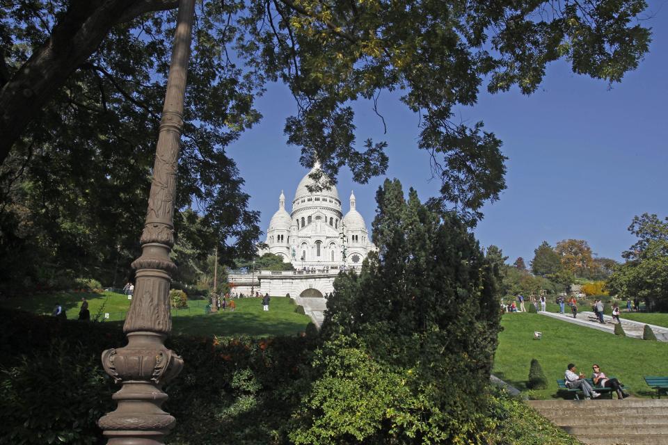 This Oct. 23, 2012 photo shows the Sacre Coeur basilica, in Paris. The landmark white domes of this basilica indelibly mark the Paris skyline, located at the city's highest point on the Montmartre hill and features the world's largest apse mosaic designed by Luc-Olivier Merson. (AP Photo/Remy de la Mauviniere)