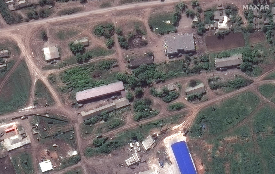 In this satellite image provided by Maxar Technologies, Russian forces are deployed in the town of Kolodyazi, approximately 11 kilometers northeast of Lyman, Ukraine, on Thursday, May 26, 2022. Vehicles are positioned near buildings throughout the town. (Satellite image ©2022 Maxar Technologies via AP)