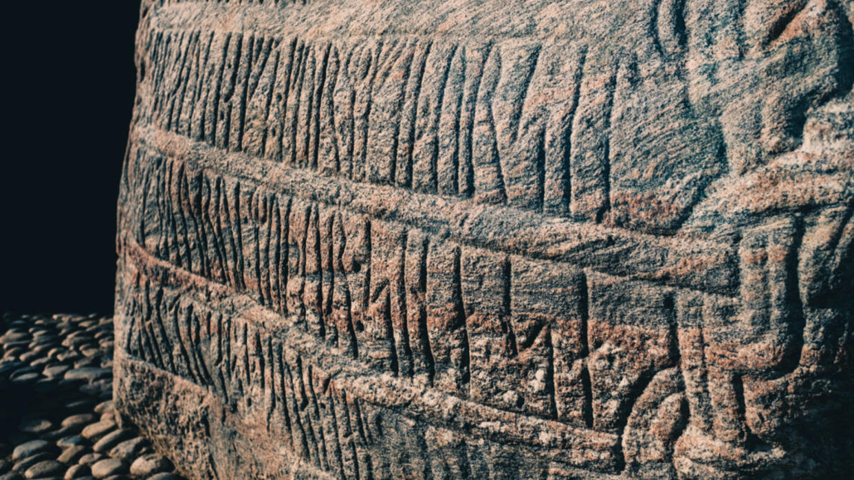  Large boulder, known as the Jelling Stone, covered in runes. 