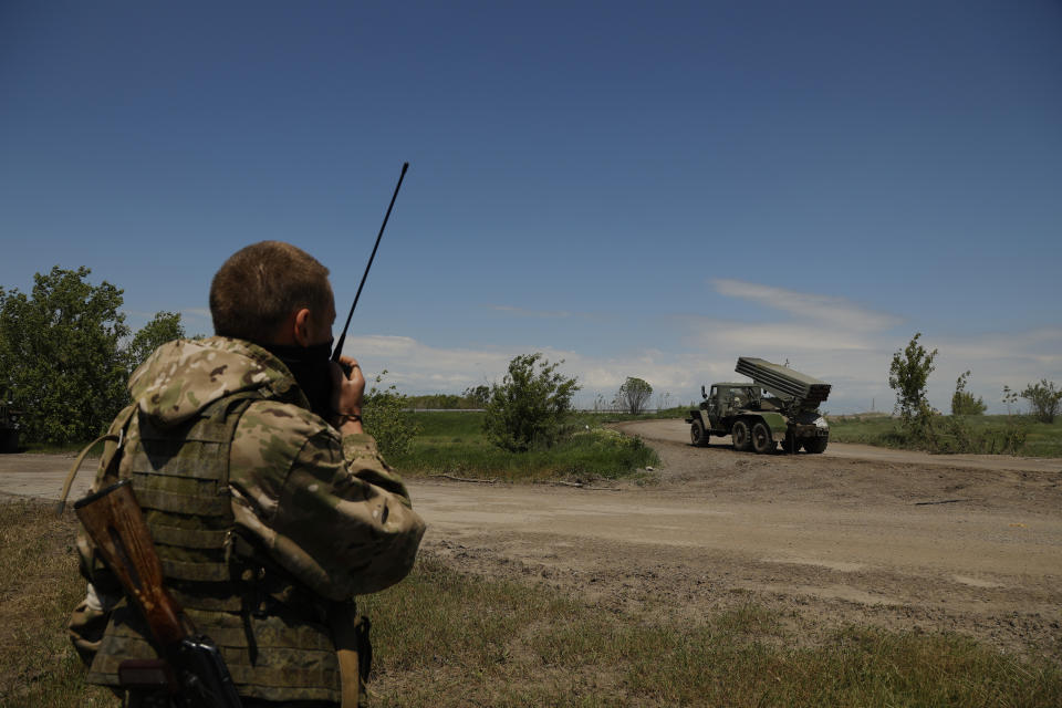 A Donetsk People's Republic militia serviceman speak on a communication device prior to fire with a multiple rocket launcher from its position not far from Panteleimonivka, in territory under the government of the Donetsk People's Republic, eastern Ukraine, Saturday, May 28, 2022. (AP Photo/Alexei Alexandrov)