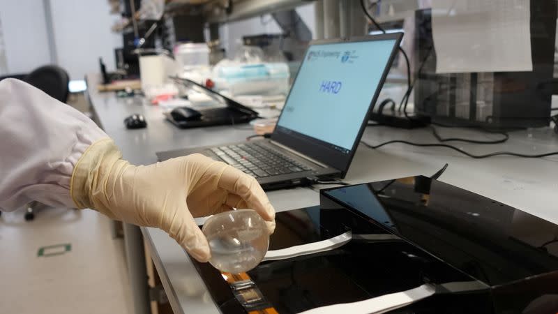 Dr. Benjamin Tee demonstrates how his device can detect the texture of a solid plastic ball at a NUS lab in Singapore