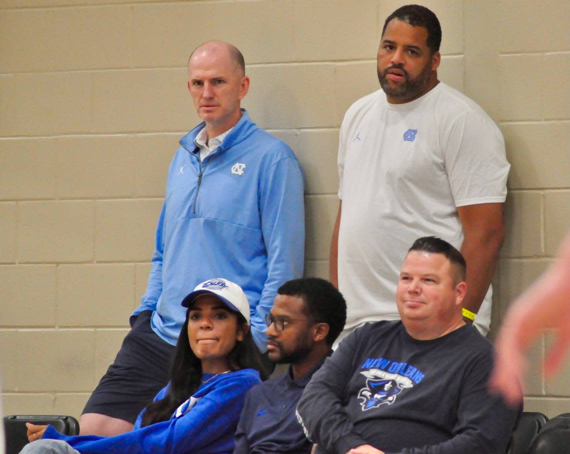 UNC assistant coaches Brad Frederick, standing left; and Sean May, standing right; hover over Duke men’s basketball general manager Rachel Baker, sitting left; and assistant coach Jai Lucas, sitting middle; while watching BABC forward T.J. Power play during Nike’s EYBL Peach Jam event in North Augusta, S.C., on Saturday, July 23.