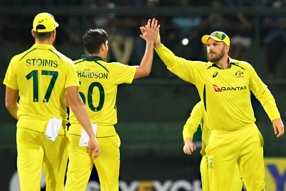 Pictured right, Australia captain Aaron Finch celebrates with teammates during the international T20 series against Sri Lanka. 