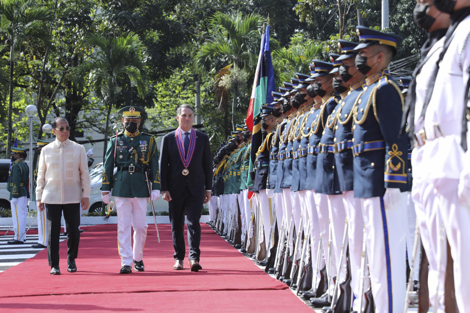 In this photo provided by the Department of National Defense, Defense Communications Service, Philippines Defense Chief Carlito Galvez Jr., left, walks with Australian Deputy Prime Minister and Defense Minister Richard Marles, right, during his visit at Camp Aguinaldo in Quezon City, Philippines on Wednesday Feb. 22, 2023. (Department of National Defense, Defense Communications Service via AP)