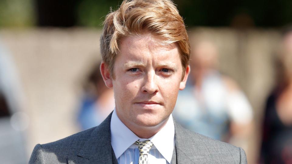 Hugh Grosvenor, Prince George's godfather, in a grey three-piece suit in the sunshine