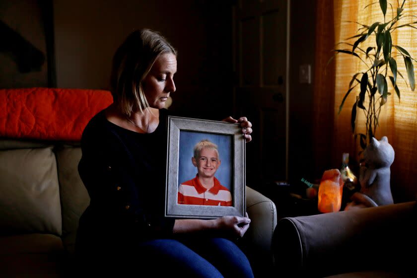 OCEANO, CA - MARCH 01: Christy Camara, 44, holding a portrait of her son Wyland Gomes taken when he was nine-years-old and in fifth-grade, at her home on Wednesday, March 1, 2023 in Oceano, CA. Wyland Gomes was 10-years-old when he was murdered by his own father, Victor Gomes, in Hanford, CA, who took his own life March 2, 2020. Christy Camara, 44, of Oceano, filed a lawsuit in the San Francisco County Superior Court against the California Department of Justice. The suit seeks to force the Department to comply with the California Public Records Act and disclose the records of a botched background check that allowed the boys killer access to a firearm, even though he had been prohibited by a state court from possessing a firearm. (Gary Coronado / Los Angeles Times)