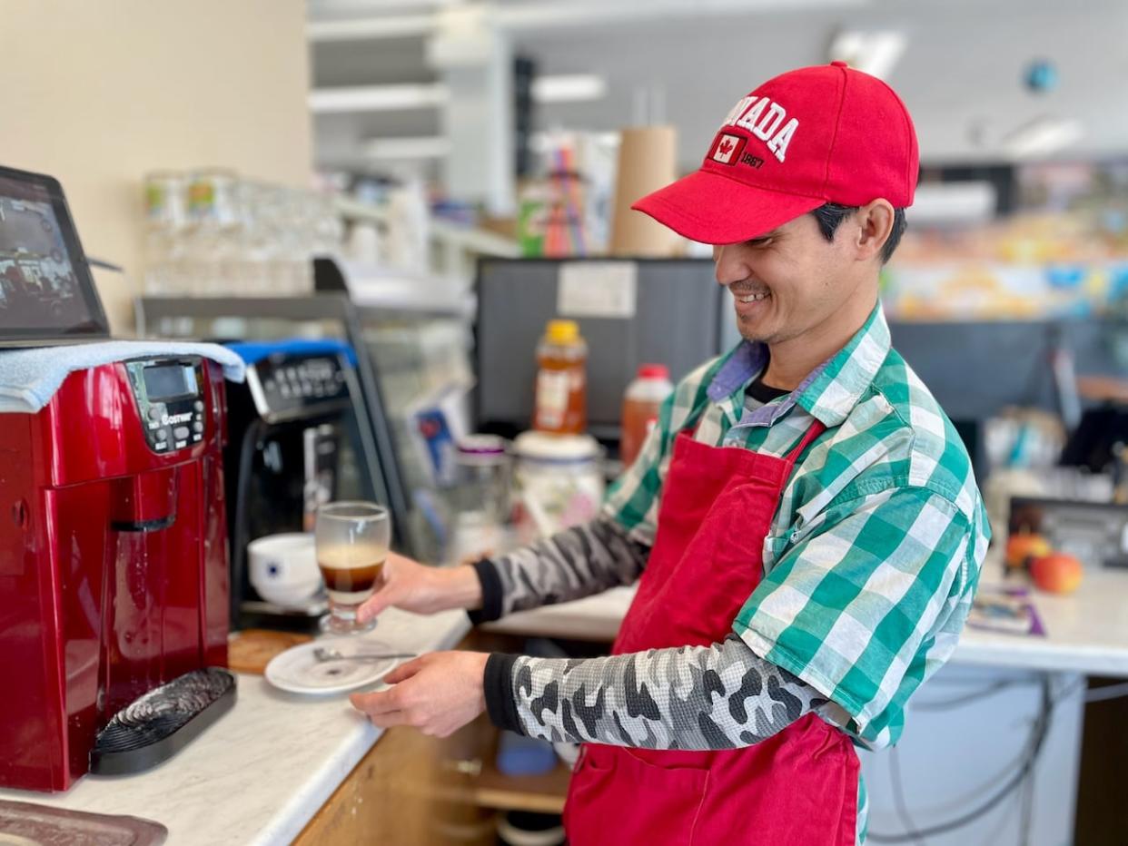 Dai Cao, the owner of G & T Book Cafe in Summerside, P.E.I., immigrated to the Island in 2020 with his family through the Provincial Nominee Program. (Steve Bruce/CBC - image credit)