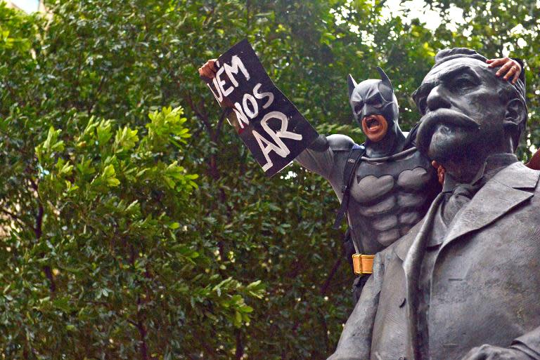 A man disguised as super hero Batman takes part in a demonstration for the Guy Fawkes World Day in Rio de Janeiro, Brazil on November 5, 2013
