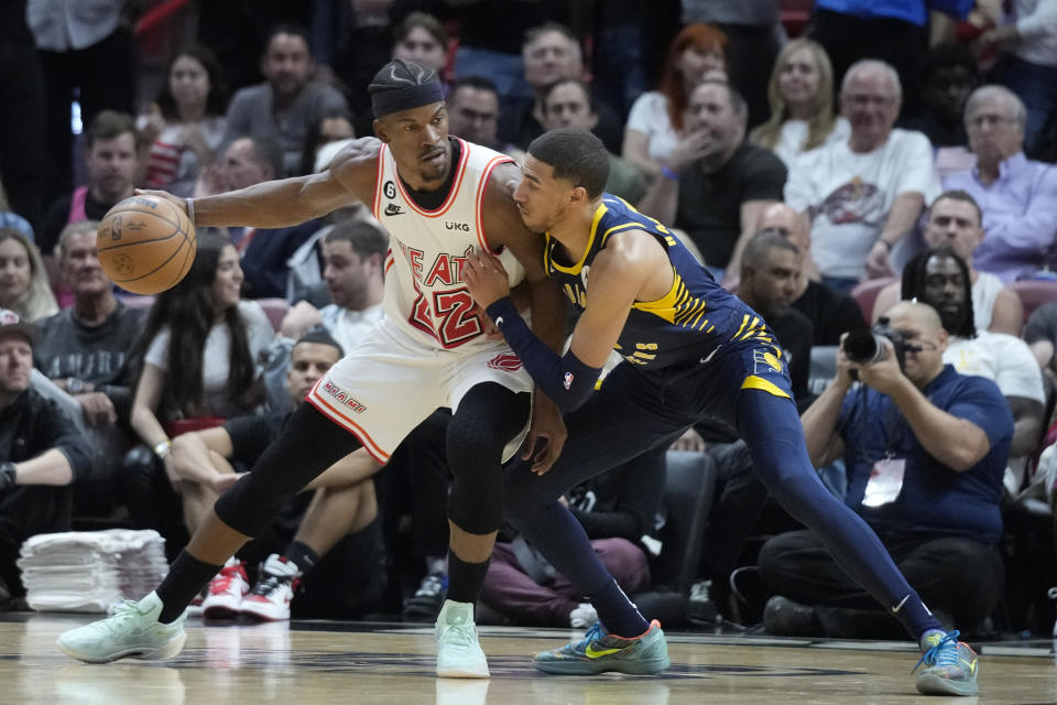 Miami Heat forward Jimmy Butler (22) drives up against Indiana Pacers guard Tyrese Haliburton during the first half of an NBA basketball game, Wednesday, Feb. 8, 2023, in Miami. (AP Photo/Wilfredo Lee)