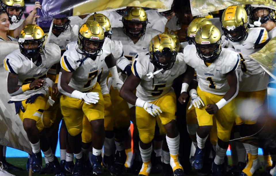 St. Thomas take the field to play Tampa Bay Tech in the Class 7A state championship game at DRV PNK Stadium, Fort Lauderdale, FL  Dec. 17, 2021. 