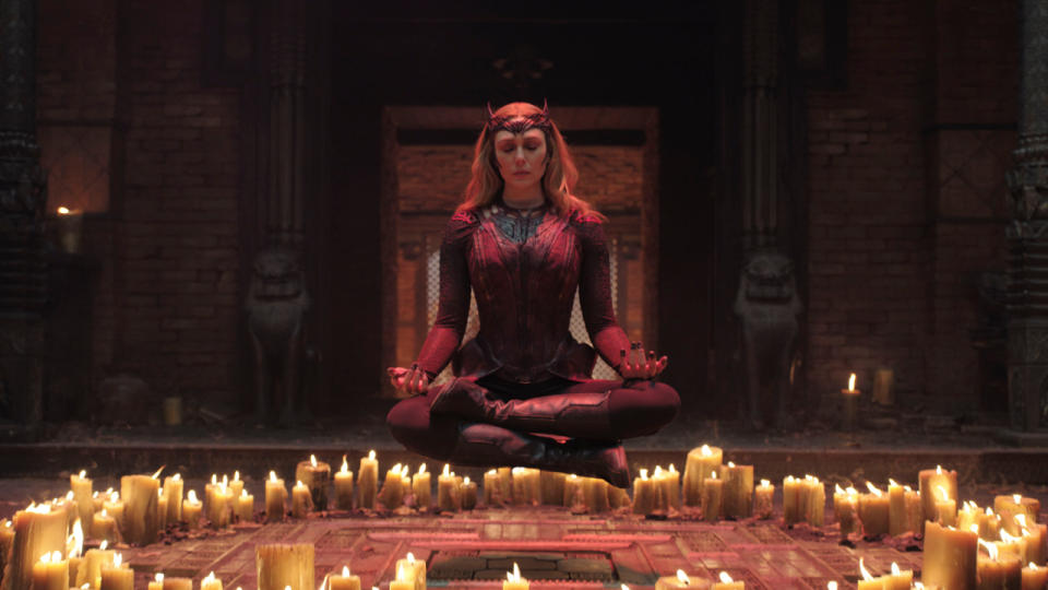 Elizabeth Olsen levitates above a ring of candles in Doctor Strange in the Multiverse of Madness.