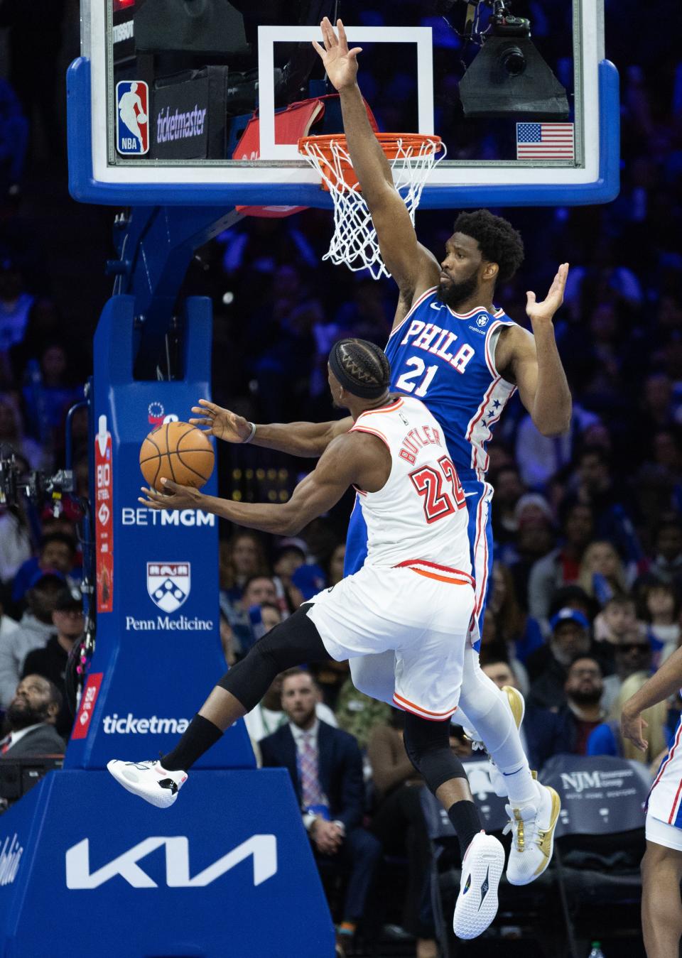 Feb 27, 2023; Philadelphia, Pennsylvania, USA; Miami Heat forward Jimmy Butler (22) shoots against Philadelphia 76ers center Joel Embiid (21) during the third quarter at Wells Fargo Center. Mandatory Credit: Bill Streicher-USA TODAY Sports