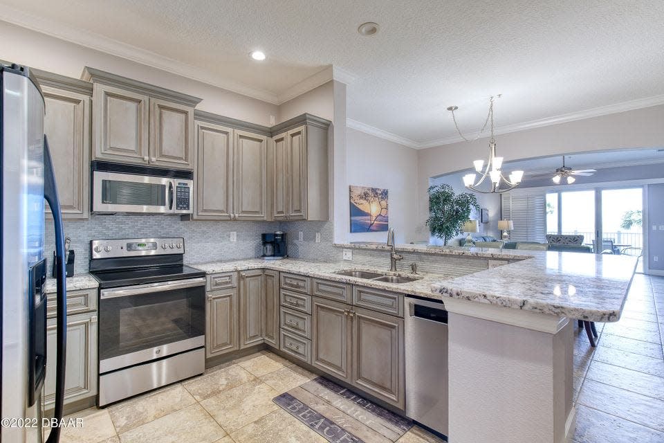 Among the many 2017 renovations is this beautiful open kitchen with custom cabinetry, granite countertops, new plumbing fixtures and LED lighting.