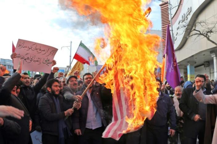 Iranian men burn a US flag during a protest in support of the Islamic republic's government and supreme leader, Ayatollah Ali Khamenei, in the northwestern city of Ardabil (AFP Photo/STR)