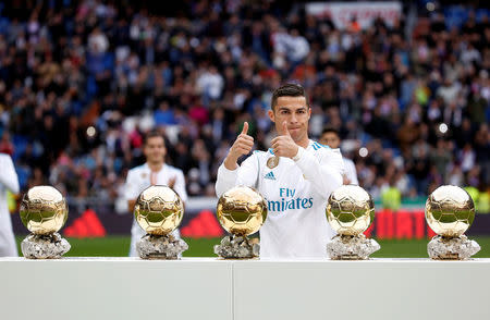 FILE PHOTO: Soccer Football - La Liga Santander - Real Madrid vs Sevilla - Santiago Bernabeu, Madrid, Spain - December 9, 2017 Real Madrid’s Cristiano Ronaldo with his five Ballon d'Or trophies before the match REUTERS/Javier Barbancho