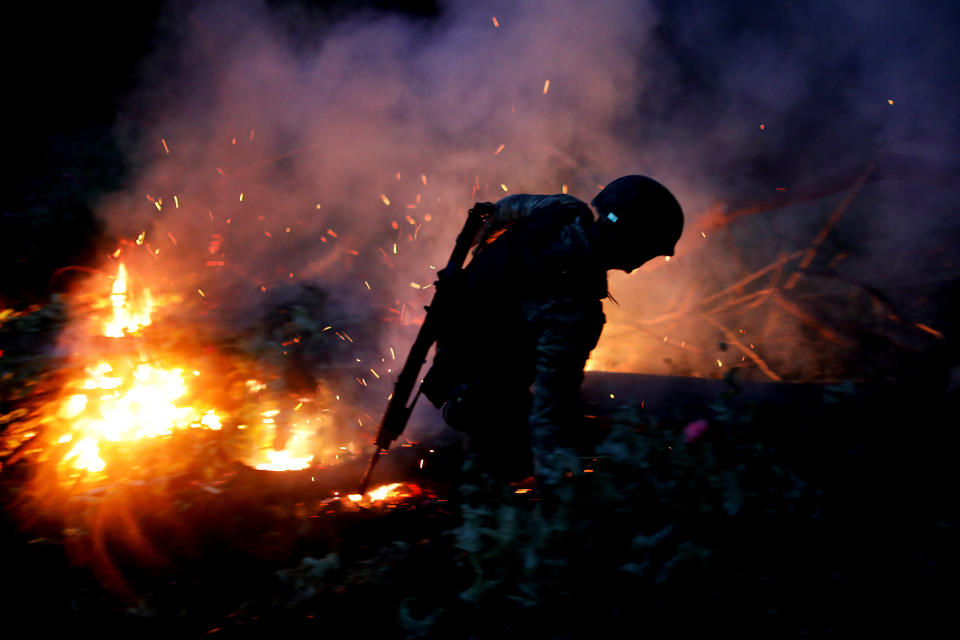 A soldier burns an illegal opium plantation 