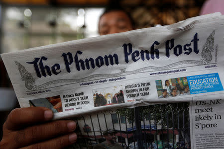 A man reads the Phnom Penh Post newspaper at a coffee shop in Phnom Penh, Cambodia, May 8, 2018. REUTERS/Samrang Pring