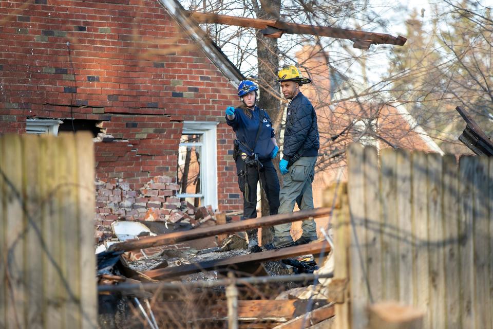 Emergency responders stand on top of debris from a house that exploded on the 18900 block of Barlow street in Detroit, where three children from a neighboring home were transported to the hospital on Tuesday, Feb. 27, 2024.