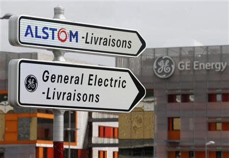 Road signs indicate directions for deliveries to French power and transport engineering company Alstom and U.S. conglomerate General Electric sites in Belfort, April 27, 2014. REUTERS/Vincent Kessler