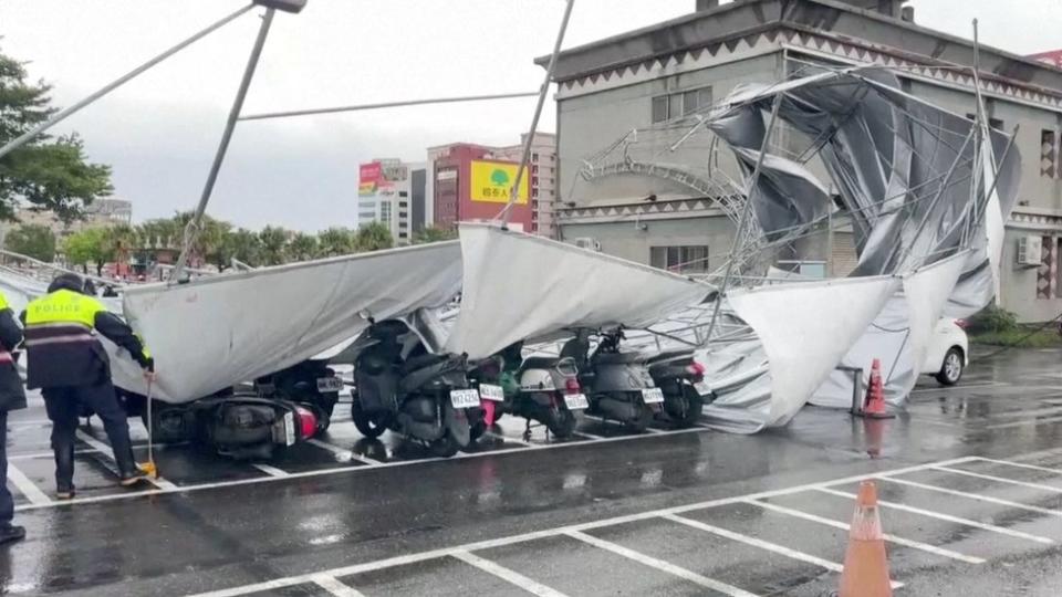 A collapsed canopy over arow of parked motorbikes in Hualien city on 3/9