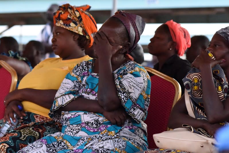 Family members of victims of an ambush on workers near a Canadian-owned mine, react during their meeting with officials in Ouagadougou