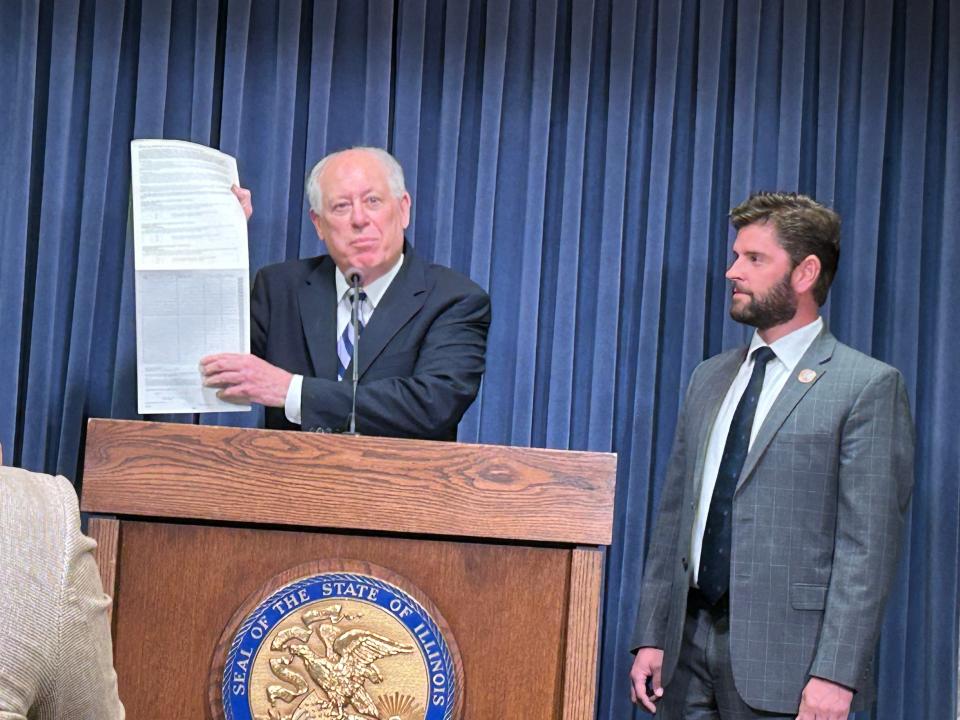 Former Gov. Pat Quinn displays the signature sheet of the 1976 Political Honesty Initiative, signed by more than 635,000 Illinois voters, during a news conference at the Illinois State Capitol on Tuesday, March 5, 2024.