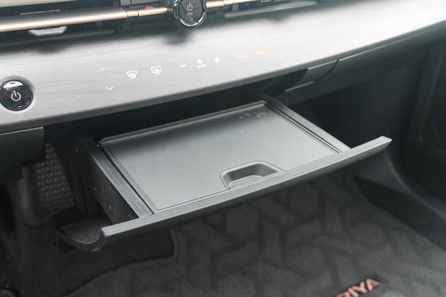 A storage drawer under the dashboard of the 2023 Nissan Ariya.