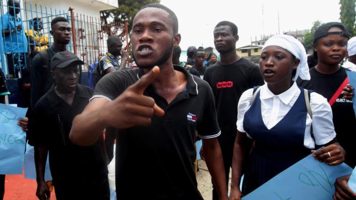 Liberians stage a rally for justice in front of the Liberia National Police headquarters in Monrovia.