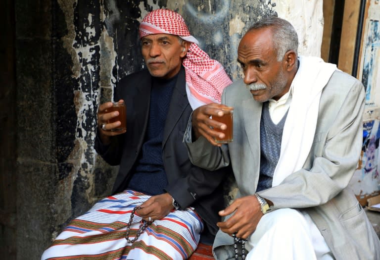 Yemenis drink coffee in Sanaa's old quarter on November 19, 2018