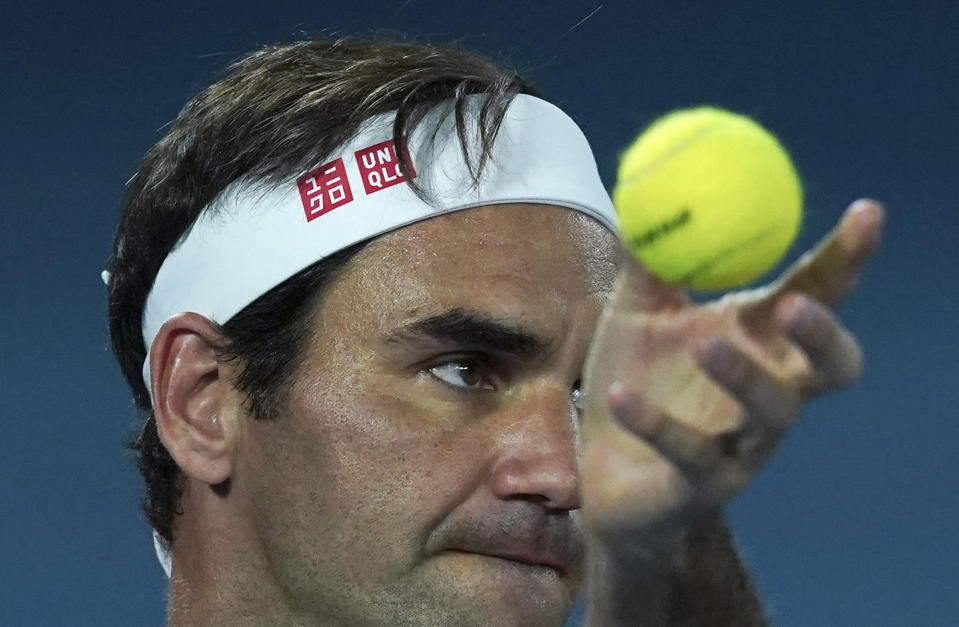 Switzerland's Roger Federer serves during a practice session ahead of the Australian Open tennis championship in Melbourne, Australia, Sunday, Jan. 19, 2020. (AP Photo/Lee Jin-man)