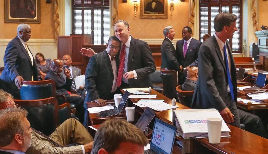 South Carolina senators John Scott and Joel Lourie hug in July after the South Carolina senate passed the second reading of a bill to remove the Confederate flag from the State House grounds.