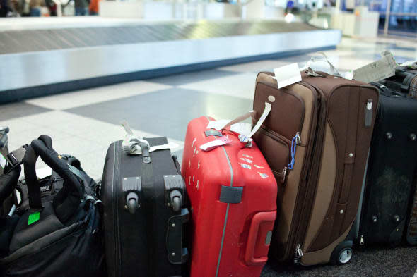 luggage lined up at the baggage claime in an airport