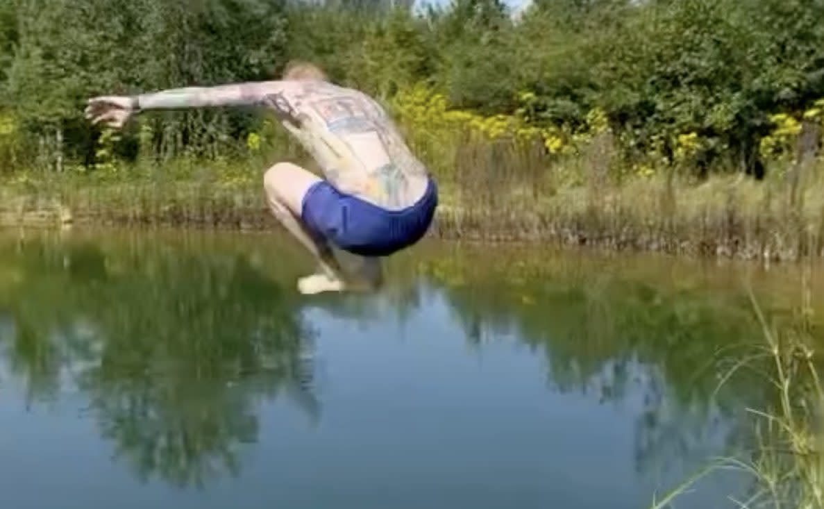 Ed Sheeran jumps into the kidney-shaped pond, which the local council had specified should not be used for 'recreational leisure activity, such as swimming'