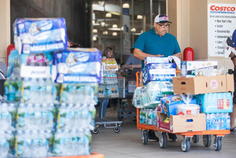 Shoppers at Costco exit the store bearing supplies ahead of the possibility of Tropical Depression Nine becoming a hurricane and impacting Palm Beach County on Friday, September 23, 2022, in Boca Raton, FL.