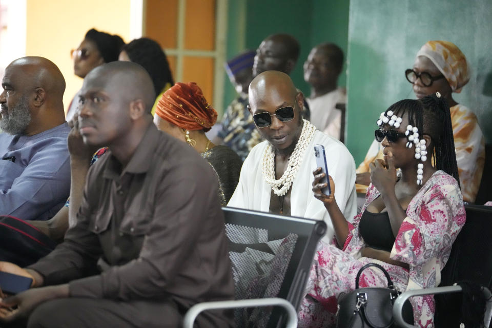 Afrobeat star, Seun Kuti, second right, waits for a court hearing at the Magistrate court in Lagos, Nigeria, Wednesday, May 24, 2023. Kuti who is facing trial on charges of assaulting a police officer will embark on a delayed concert tour after being released on bail, his manager said Wednesday. (AP Photo/Sunday Alamba)
