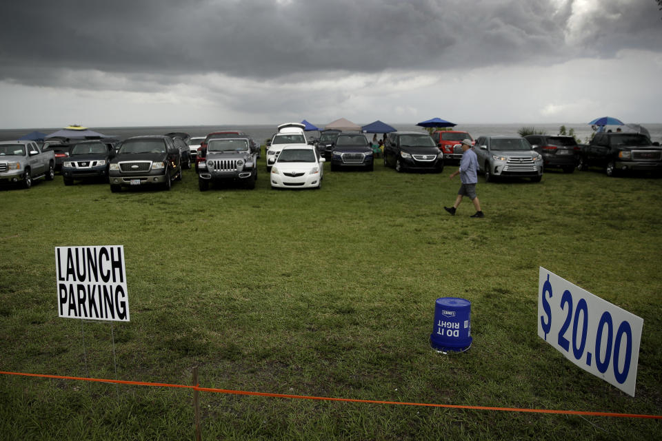 Cars park in a vacant lot in a Titusville, Fla. to watch the launch of SpaceX Falcon 9 with NASA astronauts Doug Hurley and Bob Behnken in the Dragon crew capsule, Wednesday, May 27, 2020 from the Kennedy Space Center at Cape Canaveral, Fla. The two astronauts are set to travel on the SpaceX test flight to the International Space Station. For the first time in nearly a decade, astronauts will travel to space aboard an American rocket from American soil, a first for a private company. (AP Photo/Charlie Riedel)