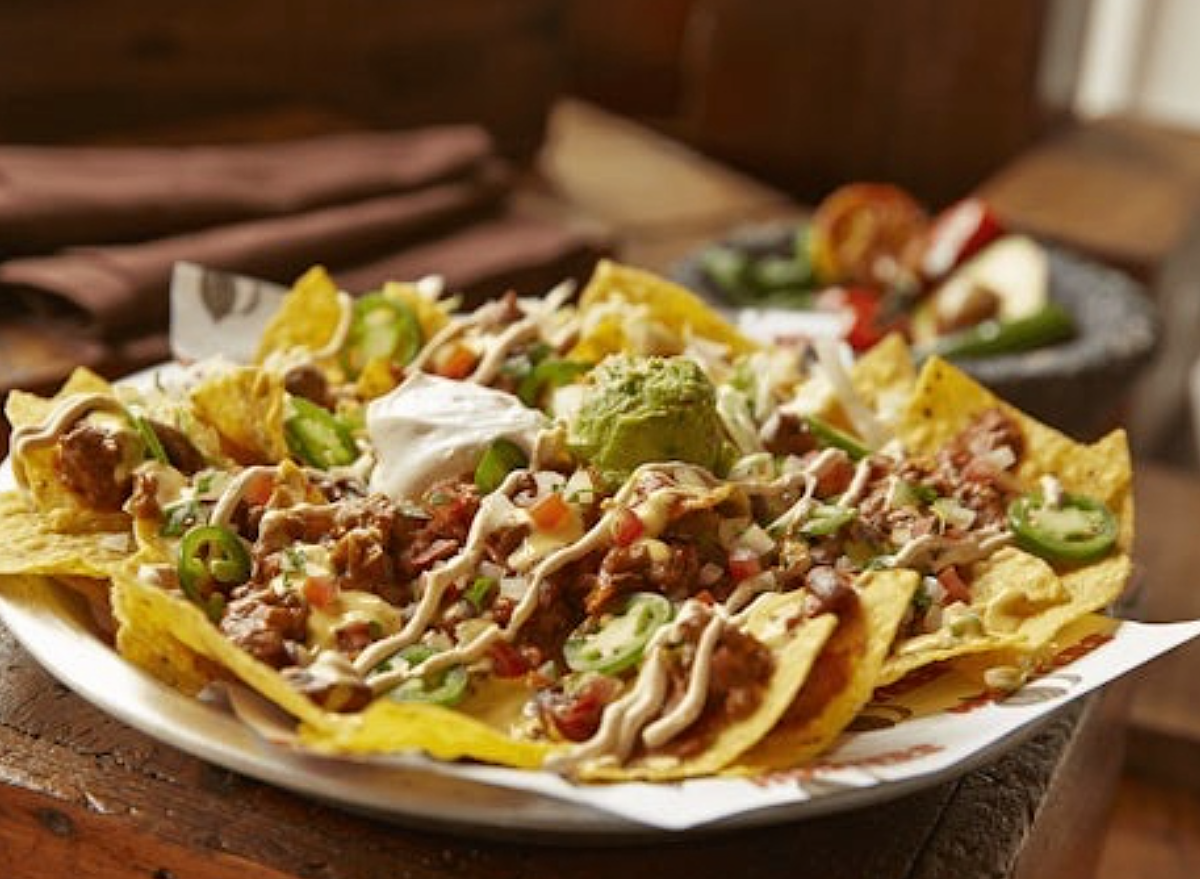 a huge plate of tex mex nachos.