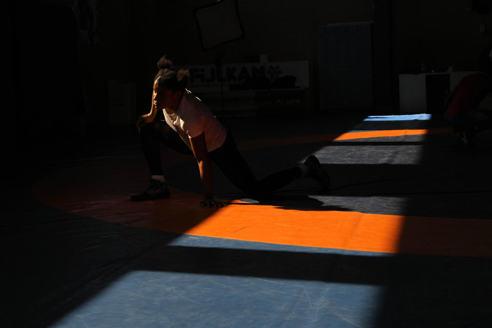 Guinean wrestler Fatoumata Yarie Camara warms up during an afternoon training session in Ostia, near Rome, Monday, July 5, 2021. Coach Vincent Aka _ a former Olympian himself, managed to secure money for a two-week June training camp in Italy. Fatoumata Yarie Camara is the only Guinean athlete to qualify for these Games. She was ready for Tokyo, but confusion over travel reigned for weeks. Guinean officials promised a ticket, but at the last minute announced a withdrawal from the Olympics over COVID-19 concerns. Under international pressure, Guinea reversed its decision. (AP Photo/Alessandra Tarantino)