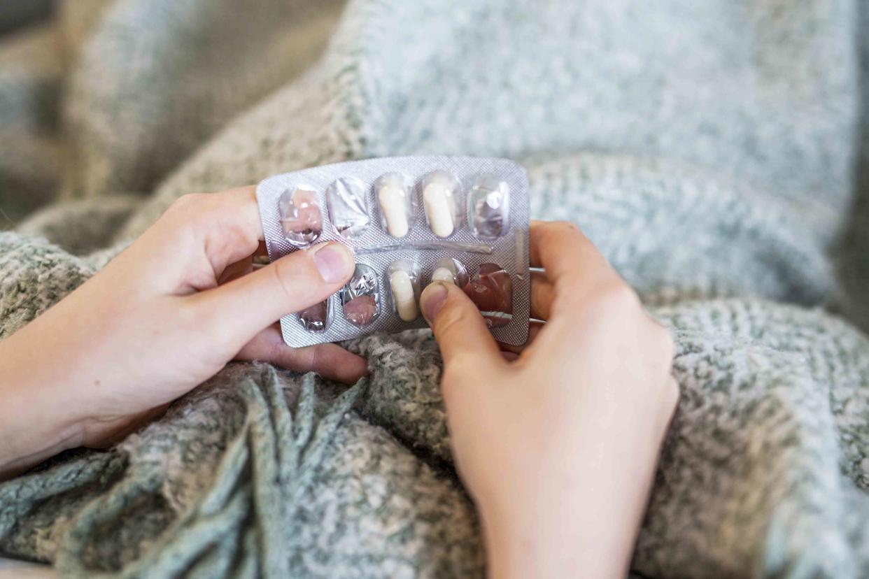 <p>Johner Images / Getty Images</p> Removing medication from a blister pack