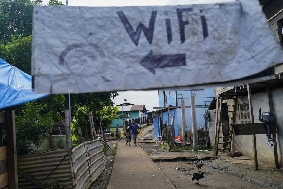 A wifi sign hangs in Bajo Chiquito where migrants heading north stop after walking across the Darien Gap from Colombia, in the Darien province of Panama, Thursday, Oct. 5, 2023. (AP Photo/Arnulfo Franco)
