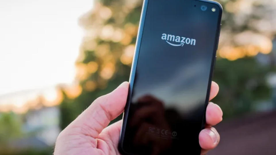 Amazon Fire Phone, held in a hand outside